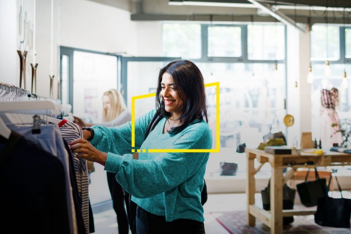 Woman browsing clothes on rack